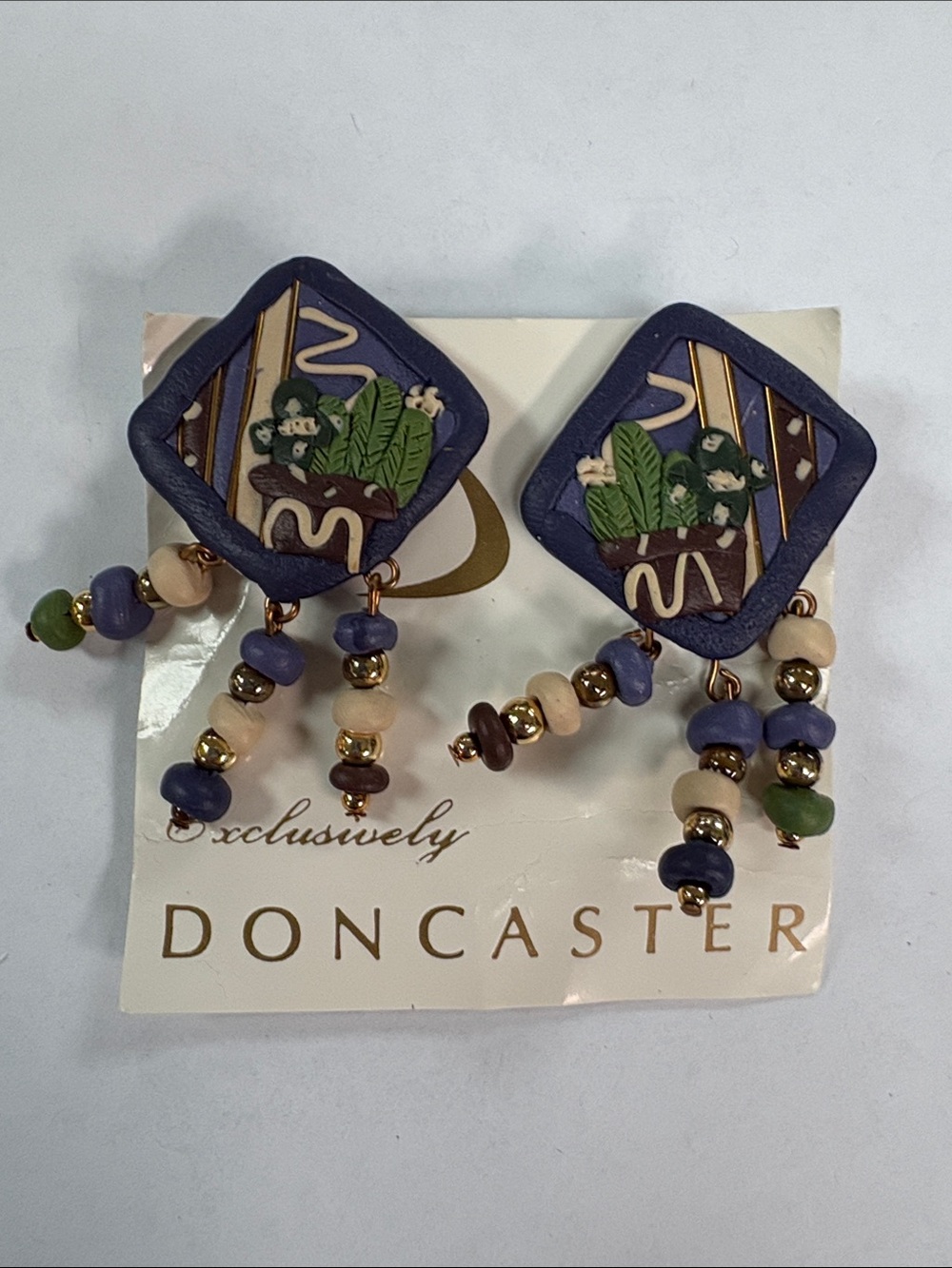 Doncaster Purple and Cream Beaded Drop clip on Earrings with Green Accents